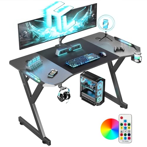 HLONONE LED Gaming Schreibtisch 120 x 60 cm, Gaming Tisch mit LED, Stabiler PC Tisch mit Kohlefaserbeschichtung, Gamer Tisch mit Getränkehalter und Kopfhörerhaken, Schwarz